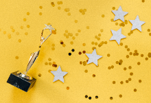 trophy and star sequins on yellow background